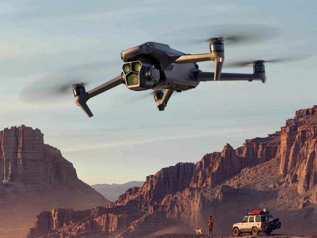 Drone flying over a canyon at sunset with a 4x4