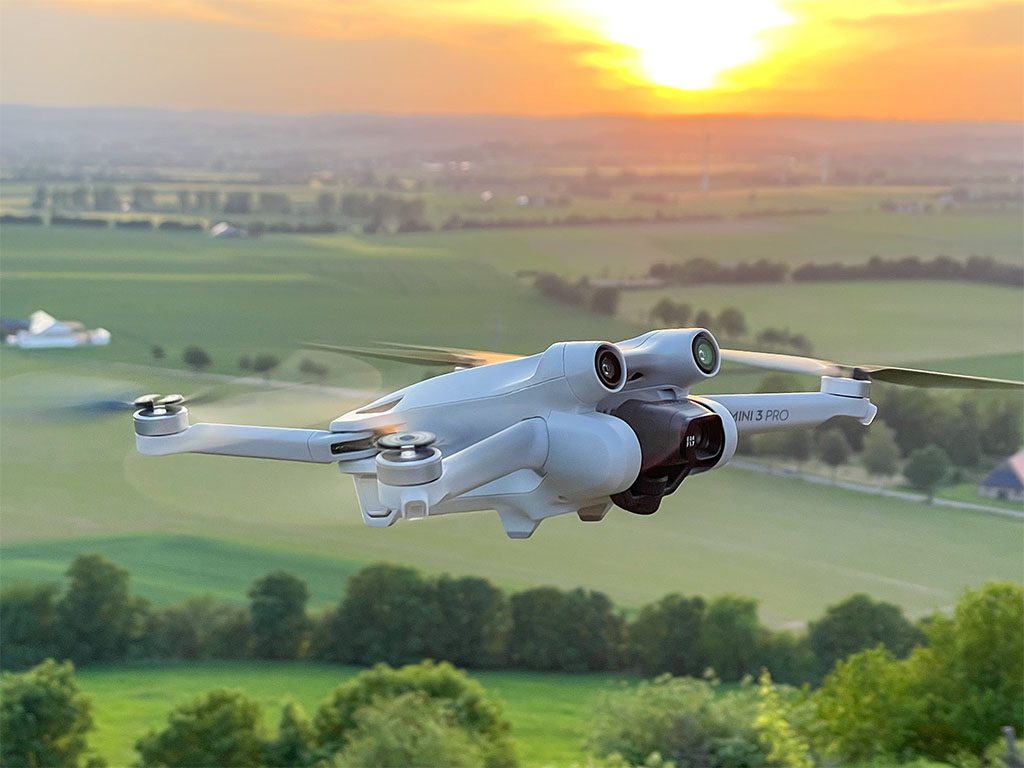 DJI Mini 3 Pro qui vole au-dessus des champs agricoles