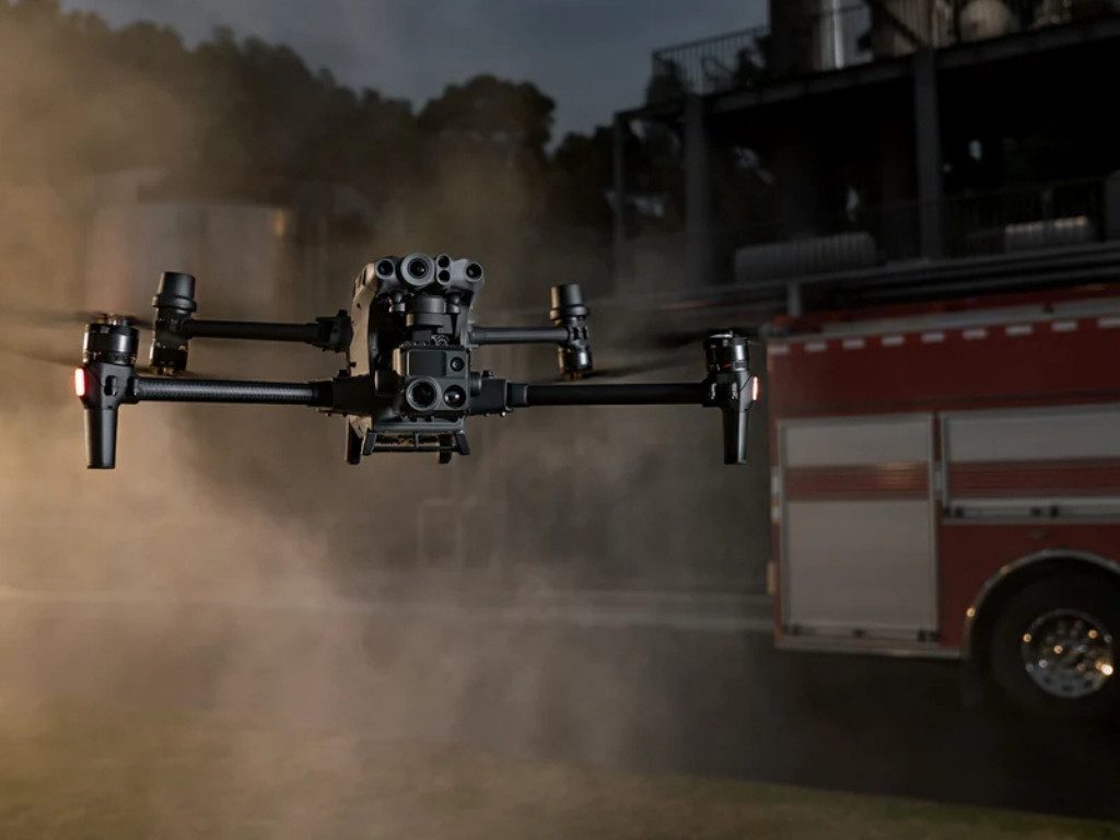 Intervention drone flying at night near a fire truck